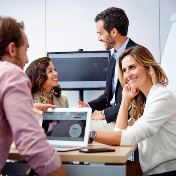 Two PEO employees looking at computer screen