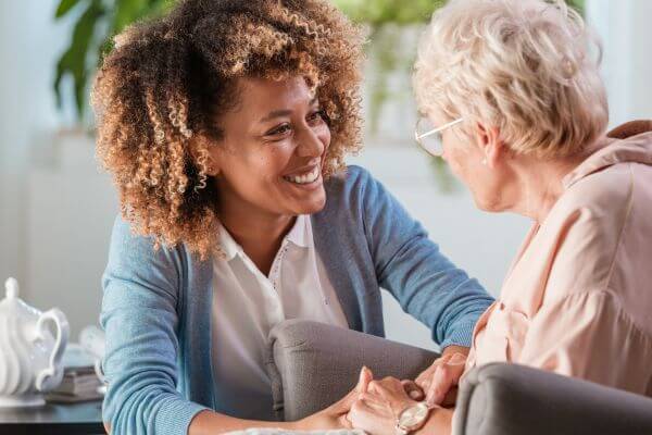 Two PEO employees looking at computer screen