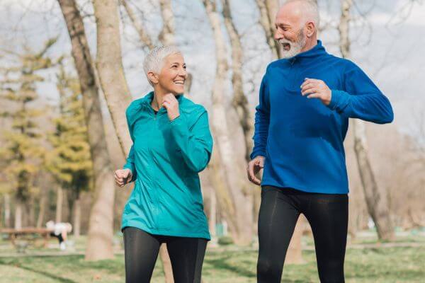 Two PEO employees looking at computer screen