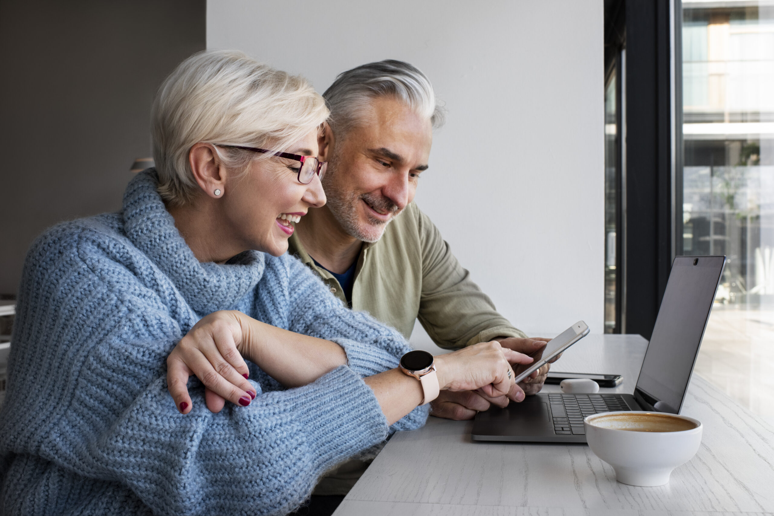 Two PEO employees looking at computer screen