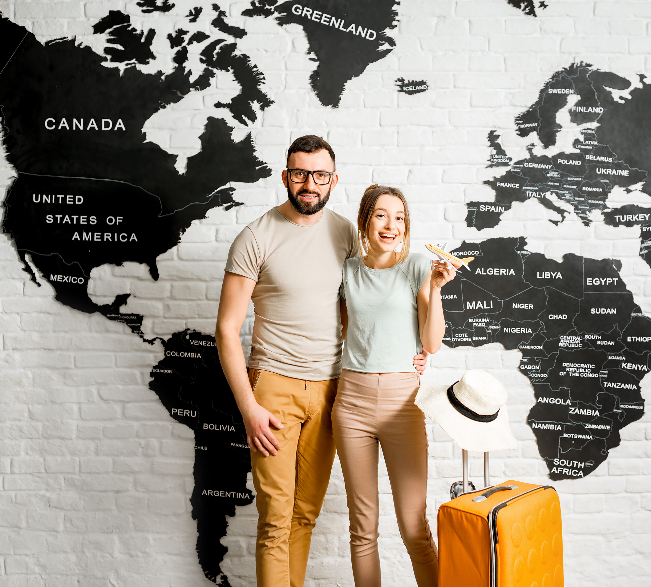 Couple of travelers on the world map background